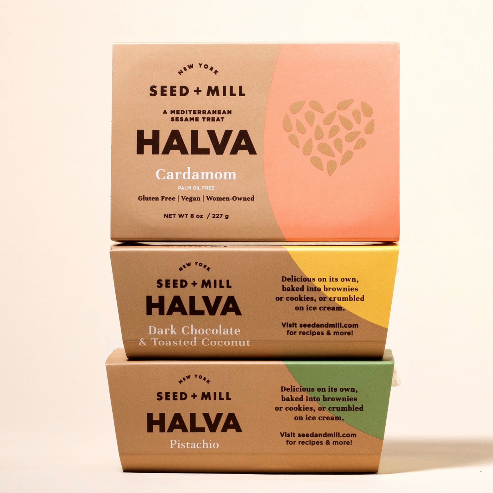 Three boxes of Seed + Mill Halva in different flavors stacked on a beige background