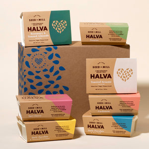 Assorted boxes of Seed + Mill Halva on a light background