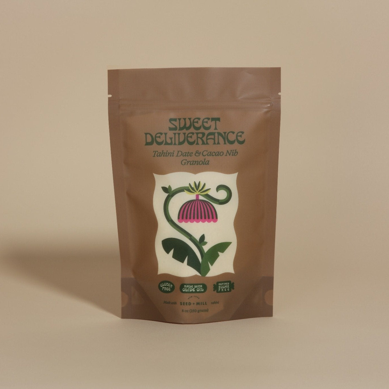 Sweet Deliverance Tahini Date & Cacao Nib granola package on a beige background
