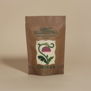 Sweet Deliverance Tahini Date & Cacao Nib granola package on a beige background