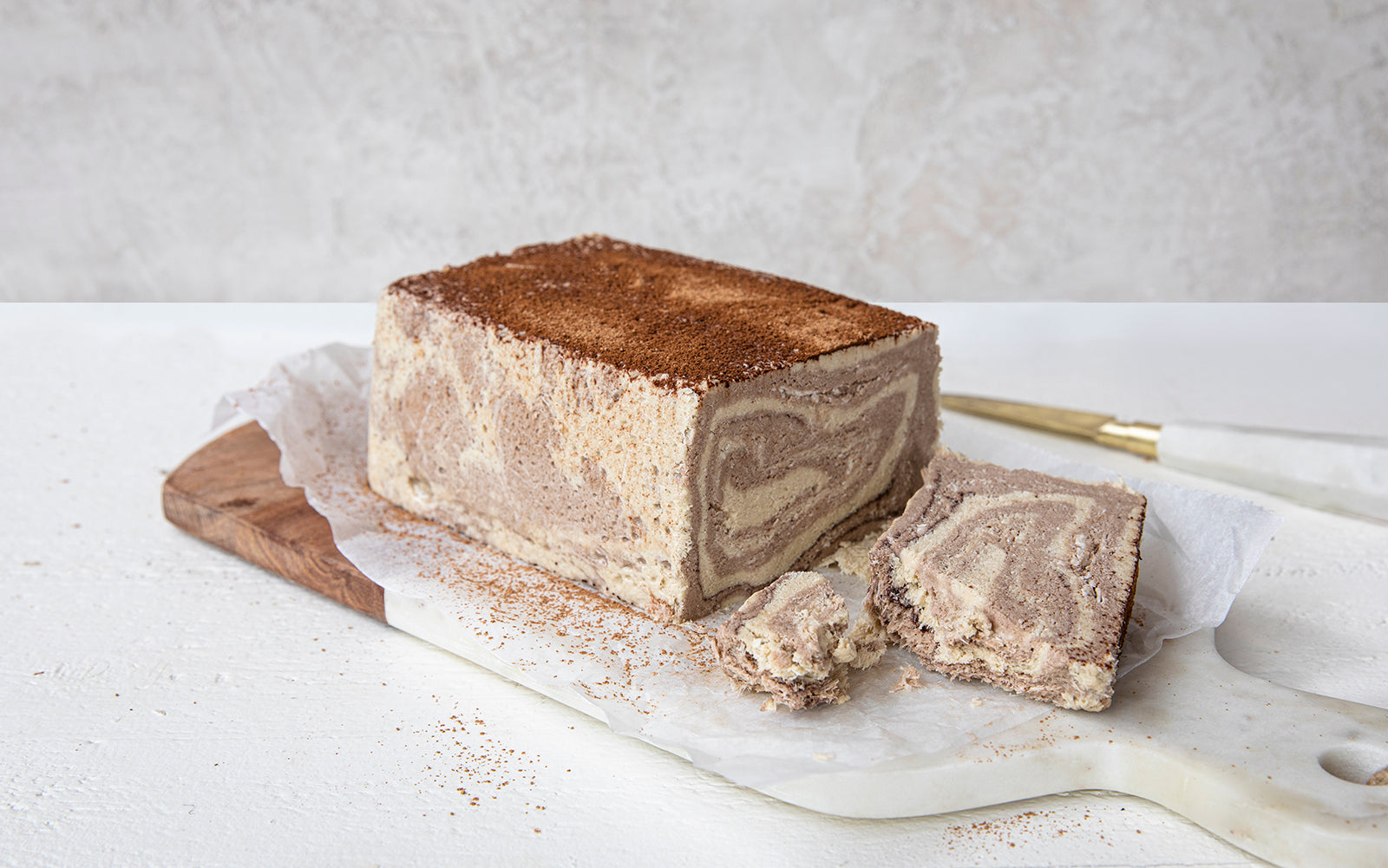 Seed + Mill marble halva loaf on a marble slab with a white background