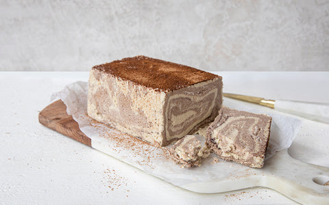 Seed + Mill marble halva loaf on a marble slab with a white background
