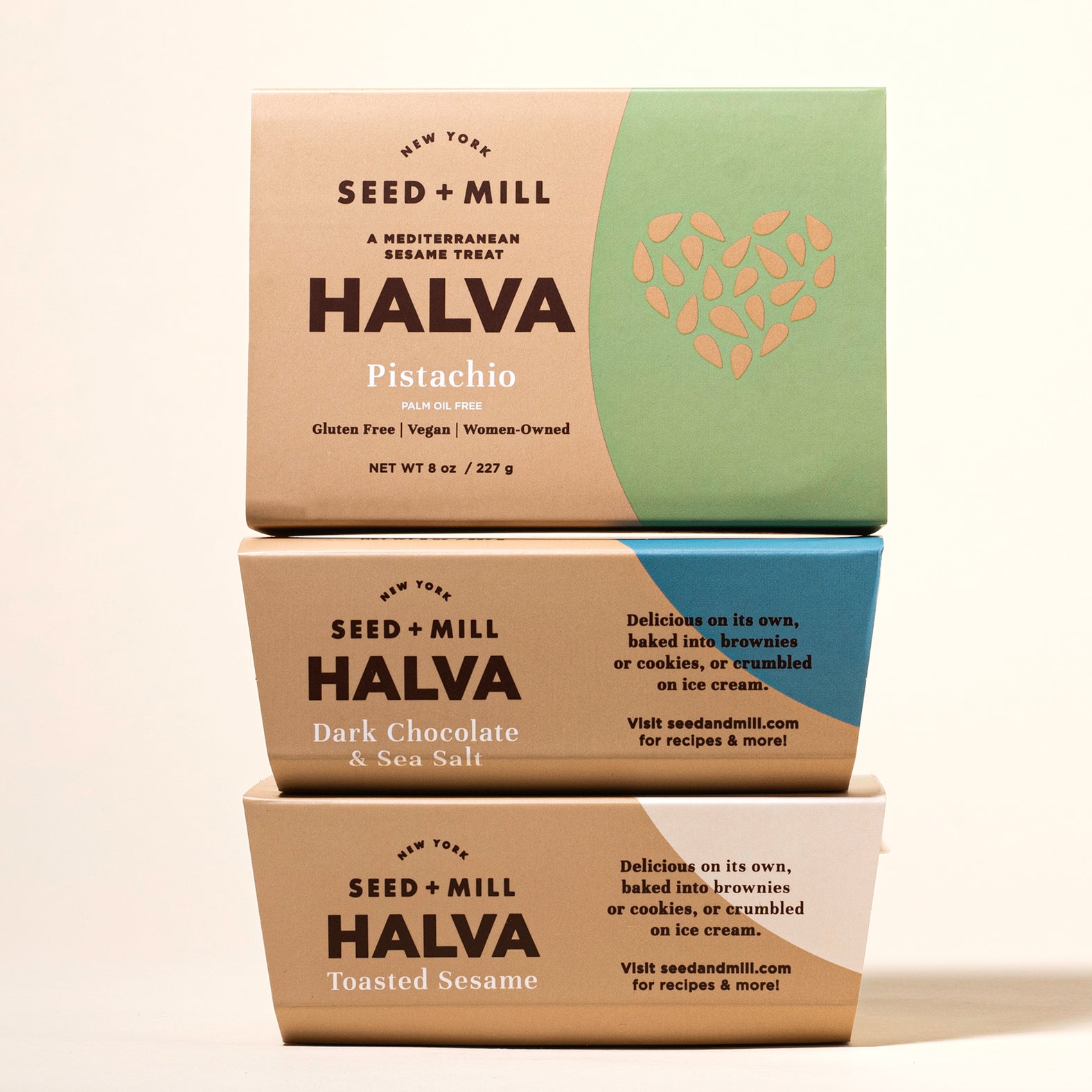 Three stacked boxes of Seed + Mill Halva on a beige background