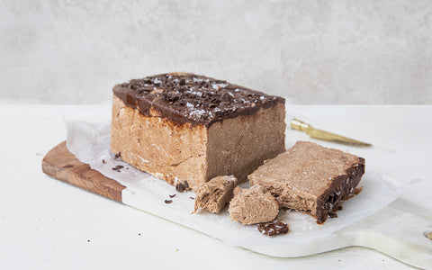 Sae Salt Dark Chocolate Halva loaf on a marble slab with a white background