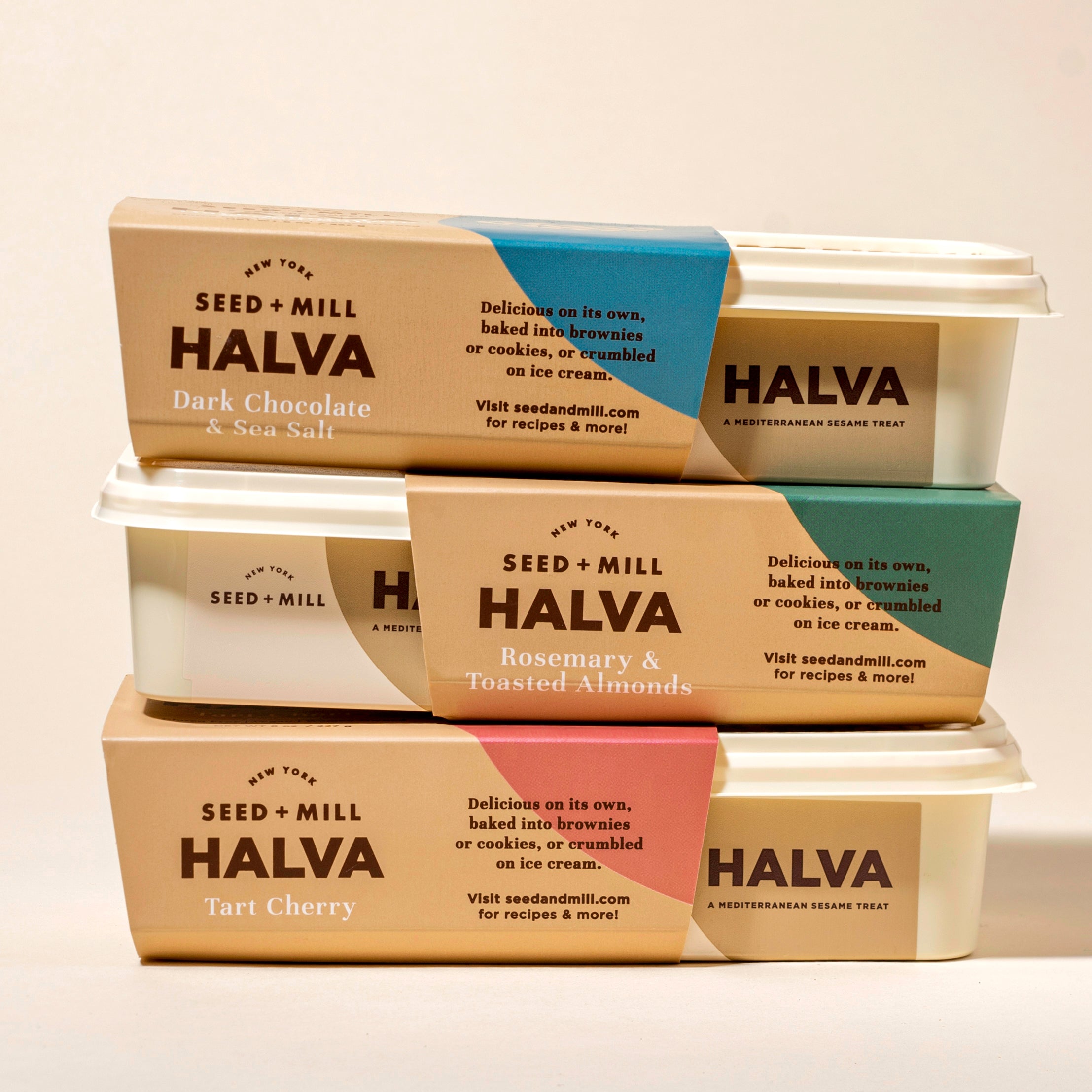 Three containers of Seed + Mill Halva stacked on a light background