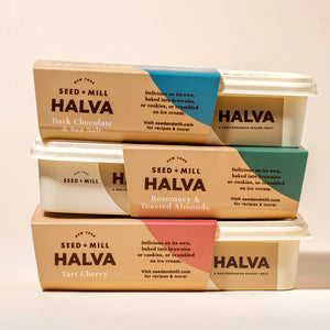 Three containers of Seed + Mill Halva stacked on a light background