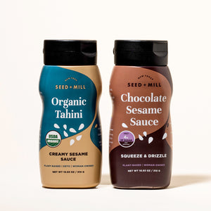 Two bottles of Seed + Mill products, Chocolate Sesame Sauce and Organic Tahini, on a beige background