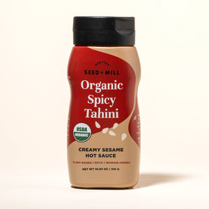 Bottle of Seed + Mill Organic Spicy Tahini Hot Sauce on a white background
