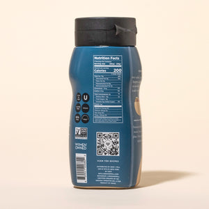 Back label of a bottle of Seed + Mill Organic Tahini with nutritional information and QR code on a beige background
