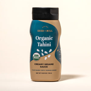 Bottle of Seed + Mill Organic Tahini on a beige background