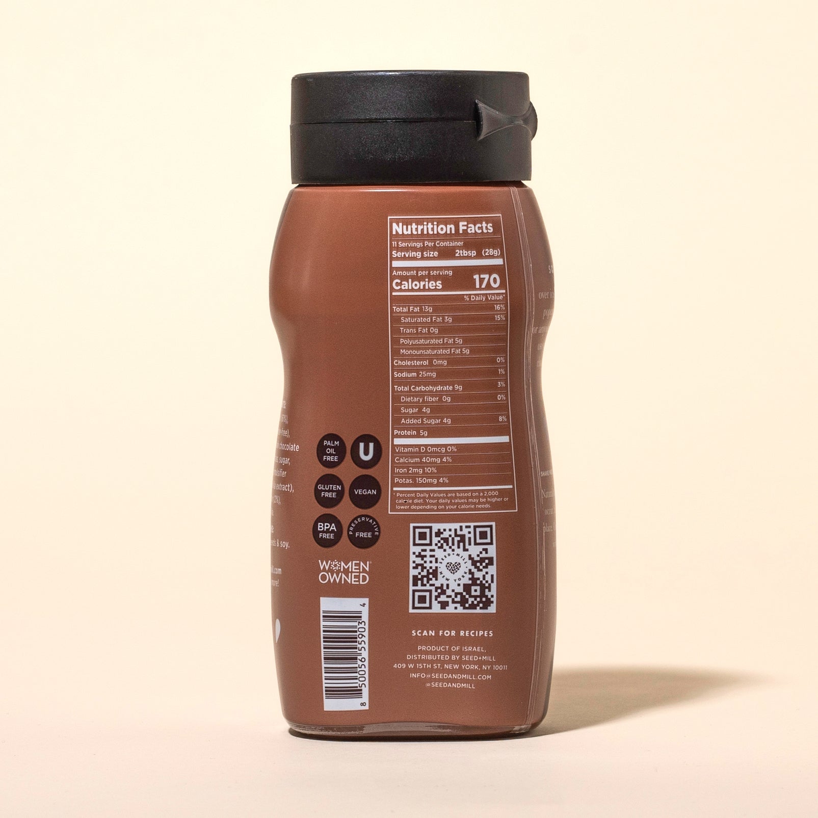 Back of a bottle of Seed + Mill chocolate sesame sauce with nutrition facts and QR code on a beige background