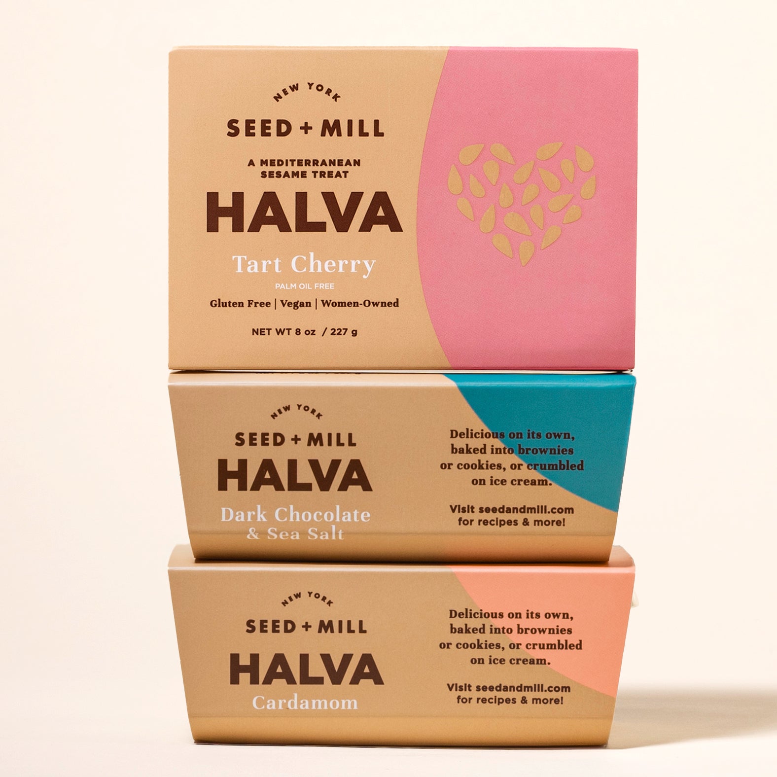 Three boxes of Seed + Mill Halva stacked on a beige background